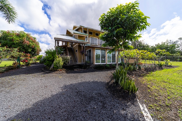 rear view of property with a balcony