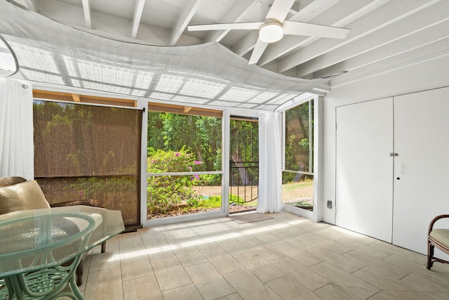 sunroom with a wealth of natural light, ceiling fan, and beam ceiling