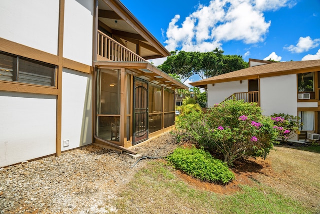 view of yard with a balcony and a sunroom