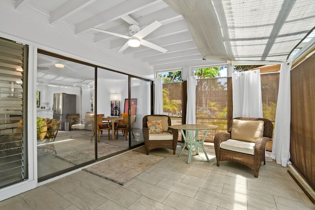 unfurnished sunroom featuring ceiling fan and lofted ceiling with beams