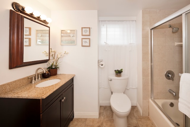 full bathroom featuring vanity, toilet, tile patterned floors, and enclosed tub / shower combo