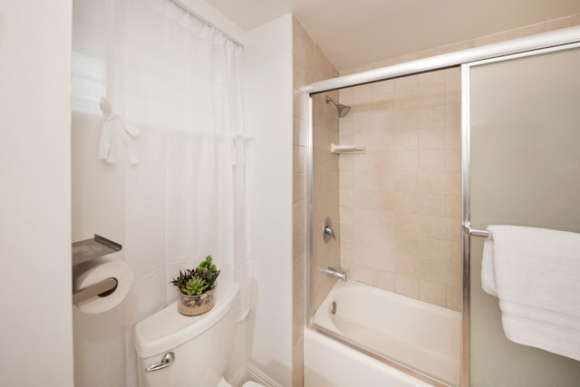 bathroom featuring tiled shower / bath and toilet