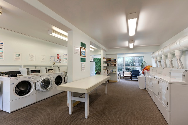 laundry room featuring dark carpet and washer and clothes dryer