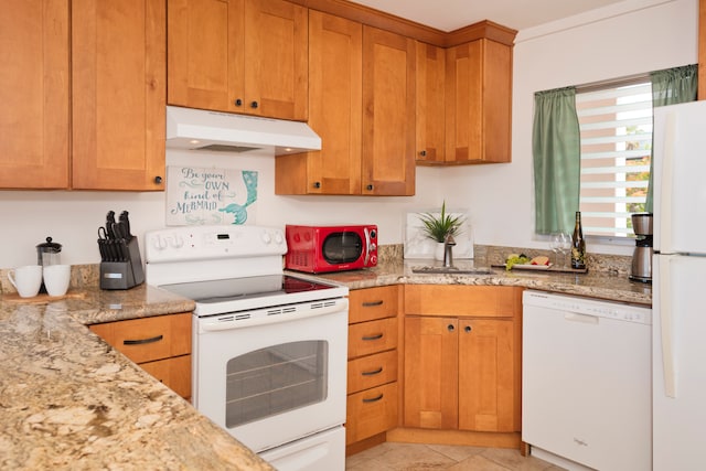 kitchen featuring light tile patterned floors, white appliances, and light stone countertops