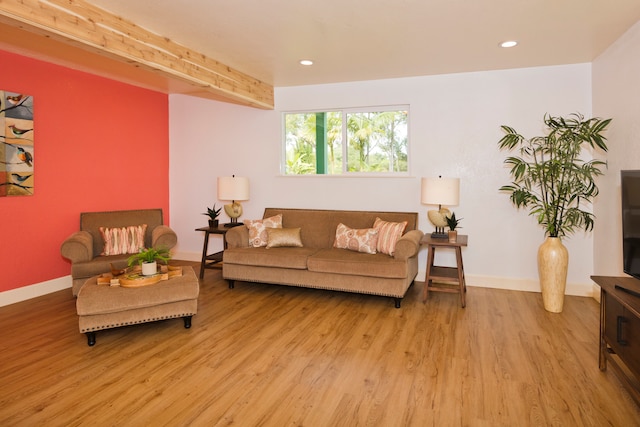 living room with beamed ceiling and light wood-type flooring