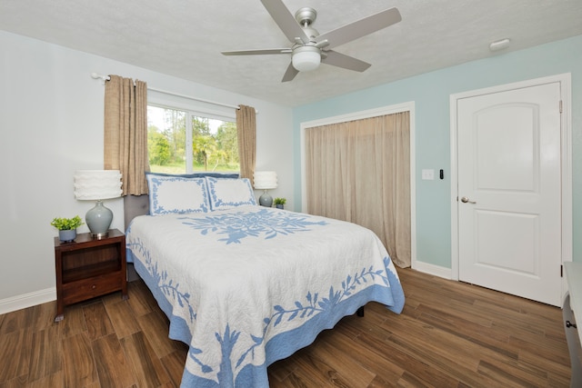 bedroom featuring ceiling fan, a textured ceiling, and dark hardwood / wood-style floors