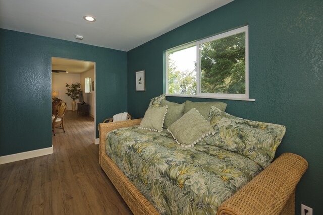 bedroom with wood finished floors, baseboards, and recessed lighting