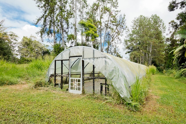 view of outdoor structure with a lawn