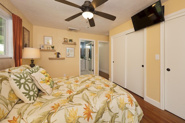 bedroom featuring wood finished floors, a closet, ceiling fan, baseboards, and connected bathroom