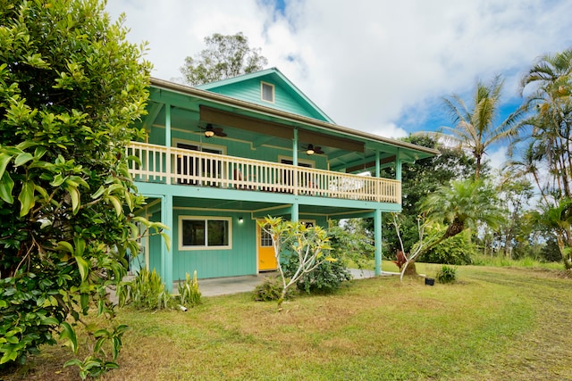 back of house featuring a yard and ceiling fan