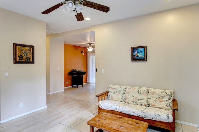 living room with ceiling fan and light hardwood / wood-style flooring