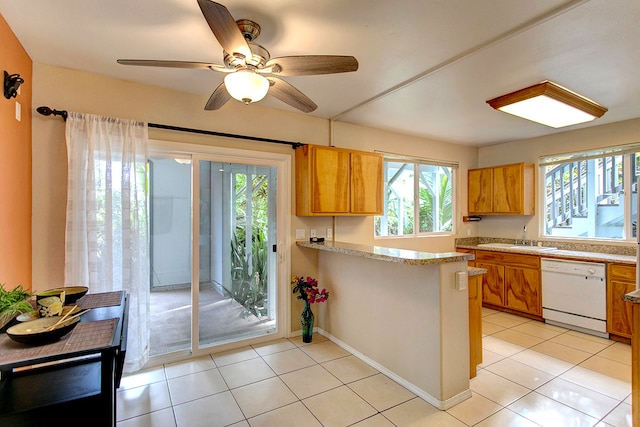 kitchen featuring a wealth of natural light, dishwasher, ceiling fan, and light tile patterned floors