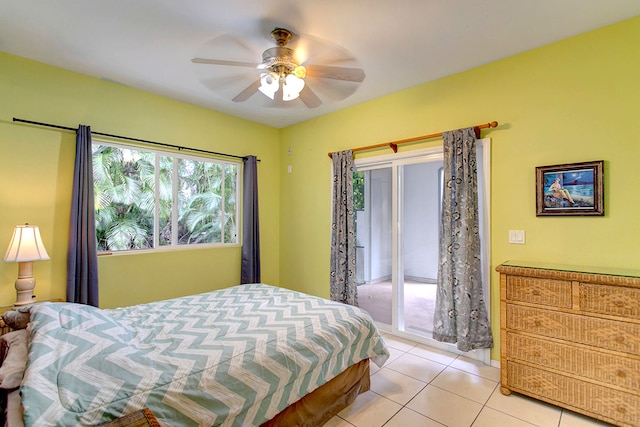 tiled bedroom featuring ceiling fan and access to exterior