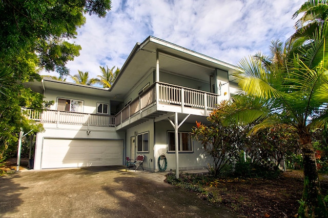 view of front of house featuring a garage and a balcony