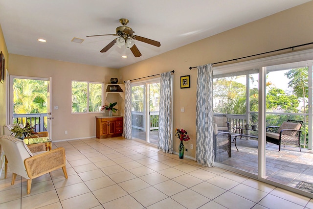 living area with ceiling fan and light tile patterned floors