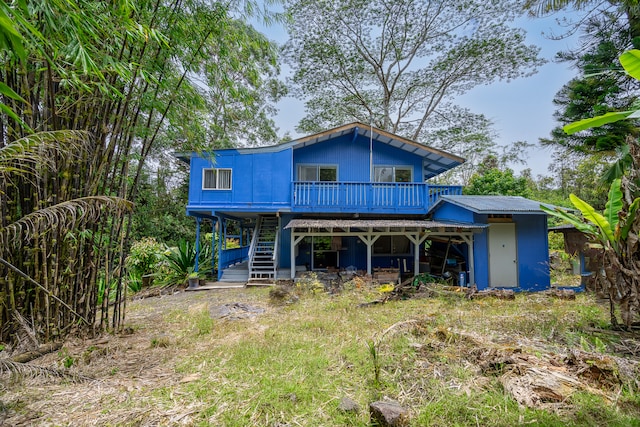 back of property with a wooden deck