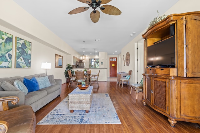 living room with dark hardwood / wood-style floors and ceiling fan