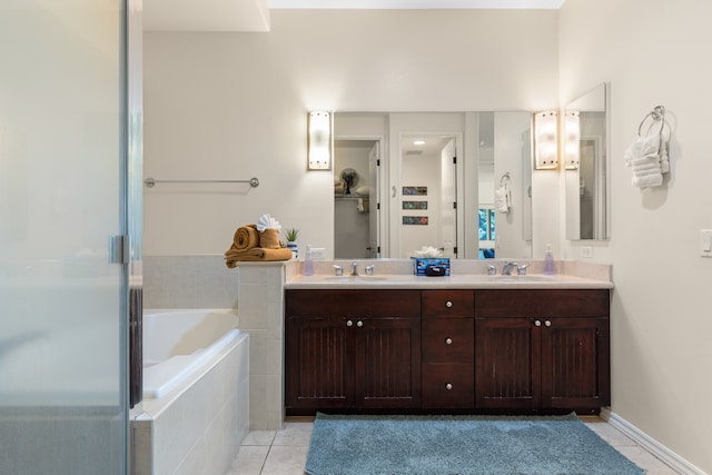 bathroom featuring tile patterned flooring, shower with separate bathtub, and vanity