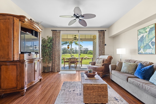 living room featuring ceiling fan and dark hardwood / wood-style floors