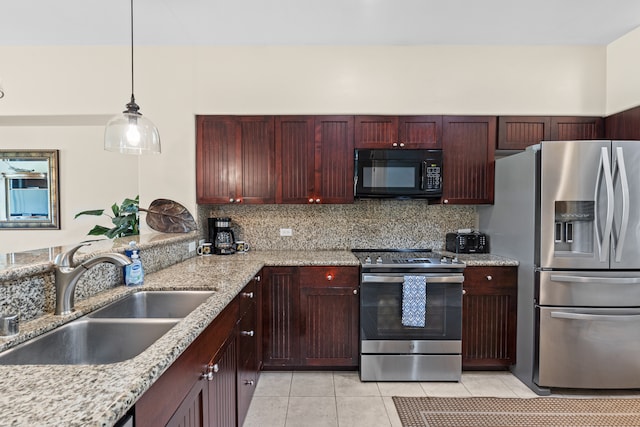 kitchen featuring backsplash, light stone countertops, sink, and stainless steel appliances