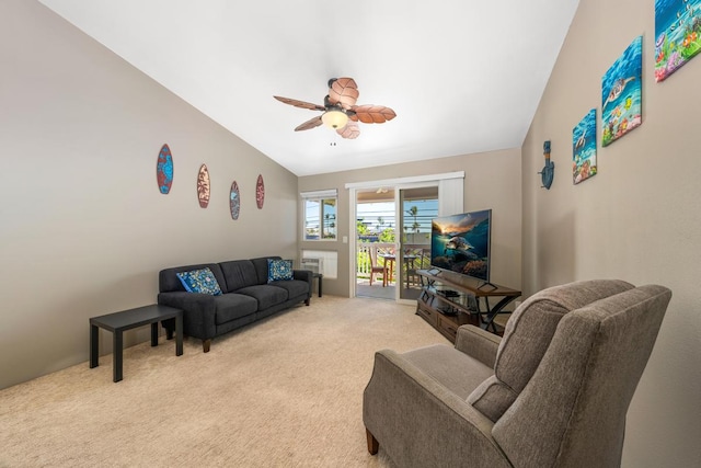 living room with light colored carpet, ceiling fan, and vaulted ceiling