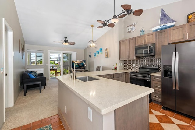 kitchen with stainless steel appliances, light carpet, sink, kitchen peninsula, and ceiling fan