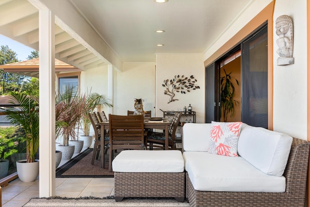 exterior space with beam ceiling and light tile patterned floors