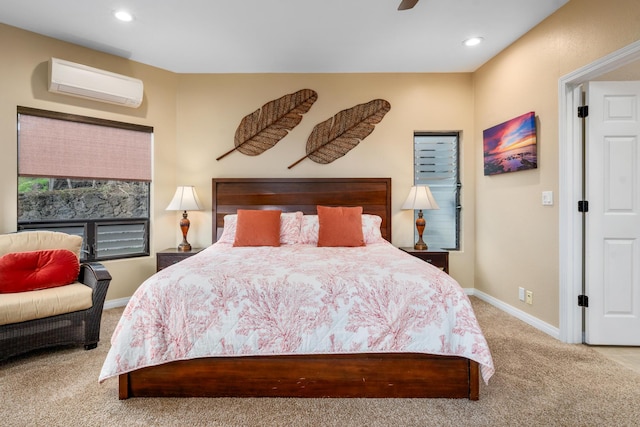 bedroom with a wall unit AC, ceiling fan, and carpet flooring