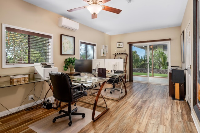 office with a wall mounted air conditioner, light hardwood / wood-style floors, and plenty of natural light