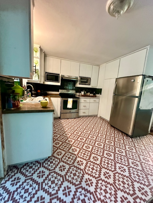 kitchen with white cabinetry, sink, and stainless steel appliances