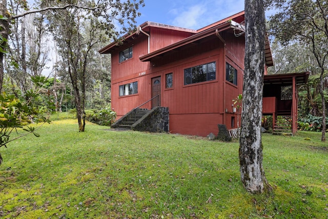 view of property exterior with a lawn