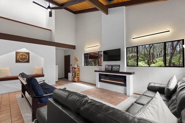 tiled living room featuring wood ceiling, ceiling fan, beamed ceiling, and high vaulted ceiling