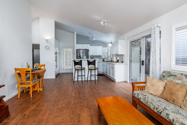 living room with lofted ceiling, ceiling fan, dark hardwood / wood-style flooring, and sink