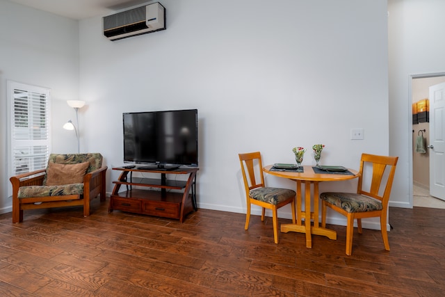 dining area featuring an AC wall unit and dark hardwood / wood-style floors