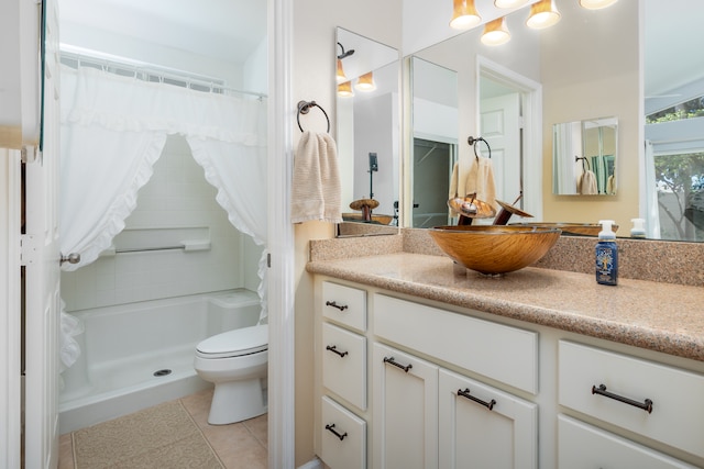 bathroom with tile patterned flooring, walk in shower, toilet, and vanity