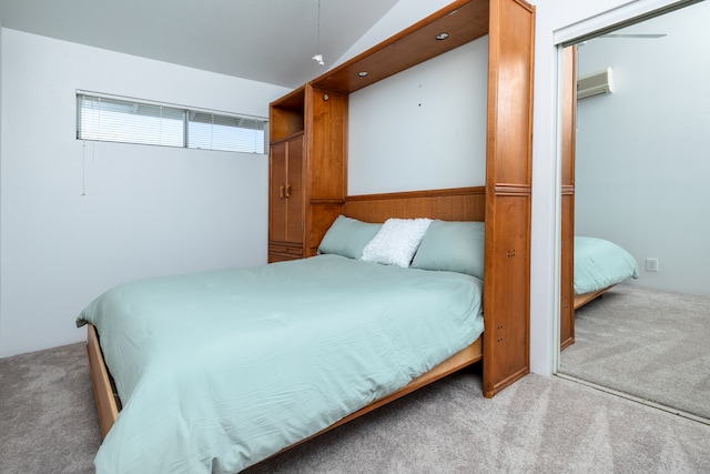 carpeted bedroom with lofted ceiling and a wall unit AC