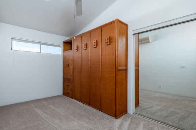 mudroom featuring light carpet and vaulted ceiling