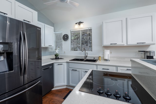 kitchen featuring vaulted ceiling, stainless steel fridge with ice dispenser, sink, white cabinetry, and ceiling fan