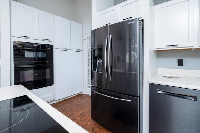 kitchen with white cabinetry, stainless steel appliances, and dark hardwood / wood-style floors