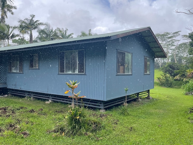 view of side of home featuring a yard