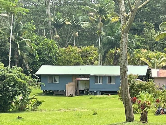 back of property with a lawn