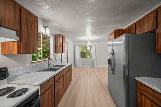 kitchen with stainless steel fridge, sink, light hardwood / wood-style flooring, range hood, and electric stove