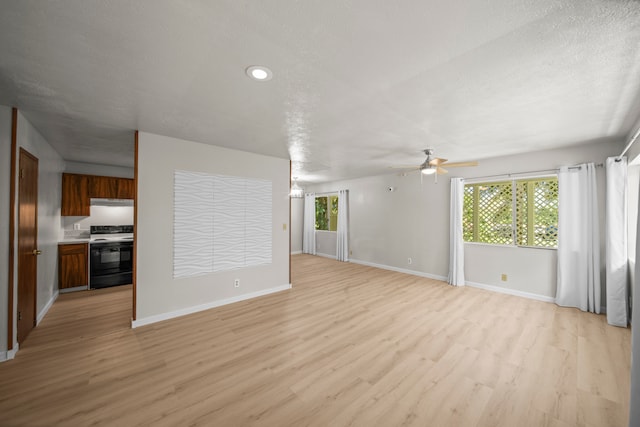 unfurnished living room featuring a textured ceiling, light hardwood / wood-style floors, and ceiling fan