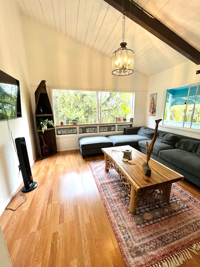 living room with an inviting chandelier, light wood-type flooring, lofted ceiling with beams, and wood ceiling