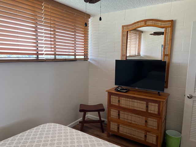 bedroom featuring a textured ceiling and dark wood-type flooring