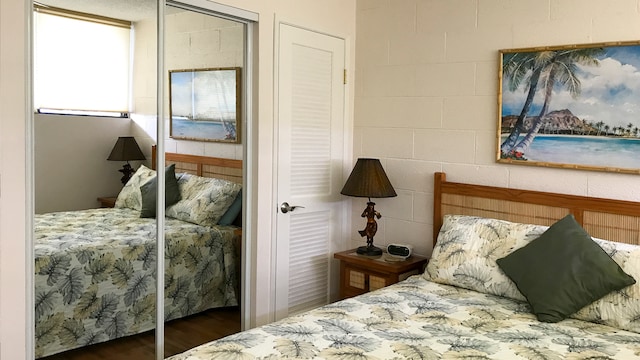 bedroom with hardwood / wood-style floors and a closet