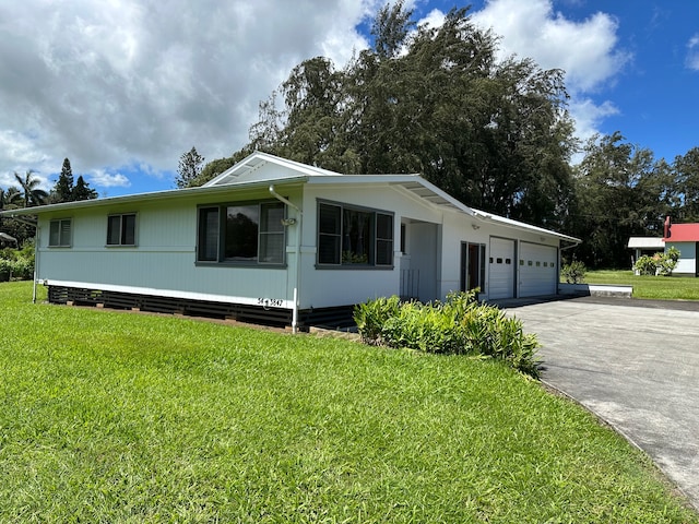 view of front of home with a garage and a front lawn