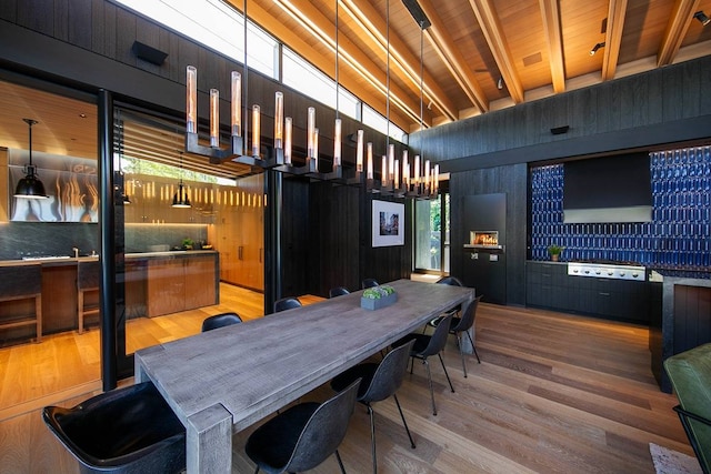 dining room with wood ceiling, hardwood / wood-style floors, and beam ceiling