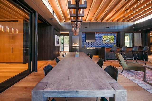 dining area featuring wooden walls and light hardwood / wood-style floors