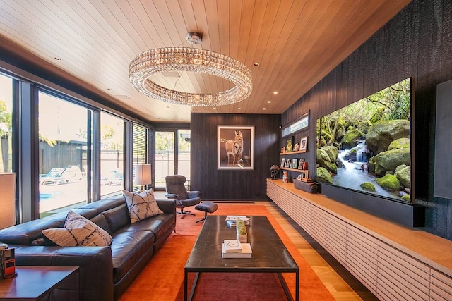 interior space with wood walls, wood ceiling, hardwood / wood-style flooring, and a chandelier